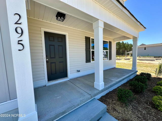 property entrance with covered porch