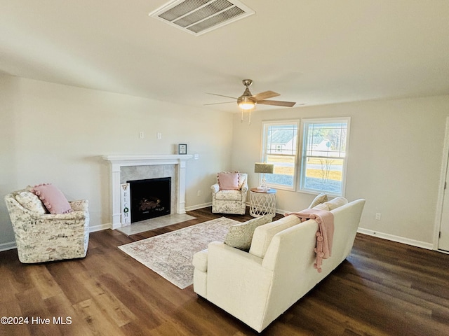 living room featuring dark hardwood / wood-style flooring and ceiling fan