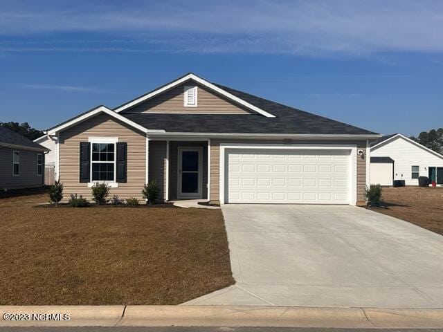 ranch-style house with a front yard and a garage