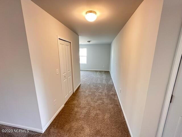 corridor with dark colored carpet