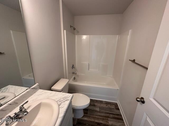 full bathroom with shower / tub combination, toilet, vanity, and hardwood / wood-style flooring