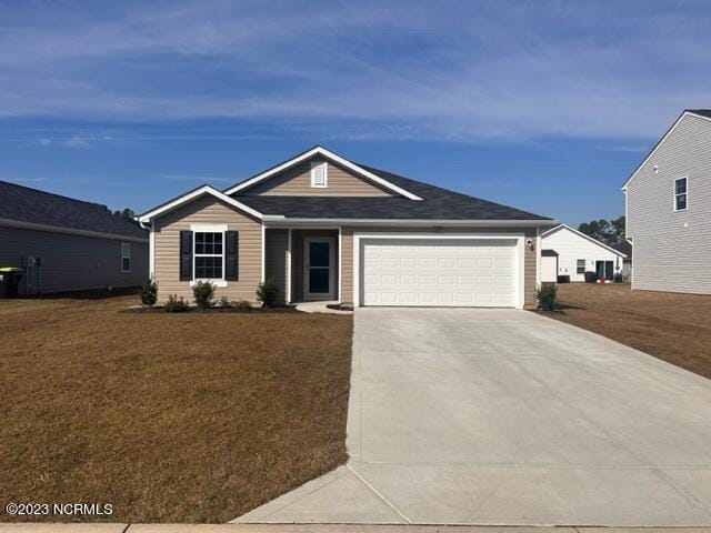 ranch-style home with a front yard and a garage