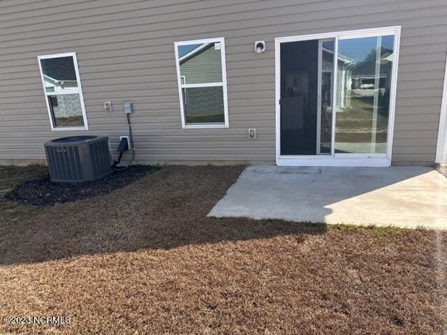 entrance to property with central air condition unit and a patio