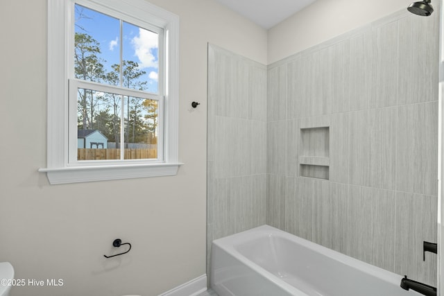 full bathroom with shower / bath combination, toilet, and baseboards