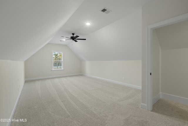 bonus room with carpet, visible vents, a ceiling fan, vaulted ceiling, and baseboards