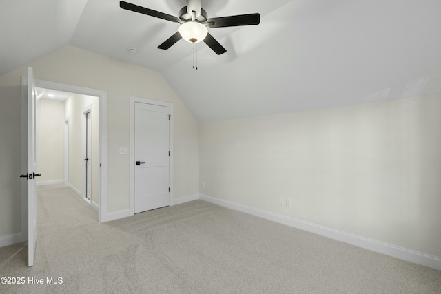 bonus room with lofted ceiling, a ceiling fan, baseboards, and carpet flooring