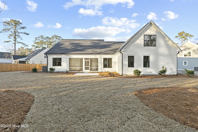 back of house featuring central AC unit and fence