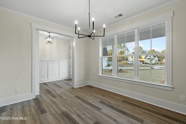 unfurnished dining area with visible vents, dark wood-type flooring, and ornamental molding