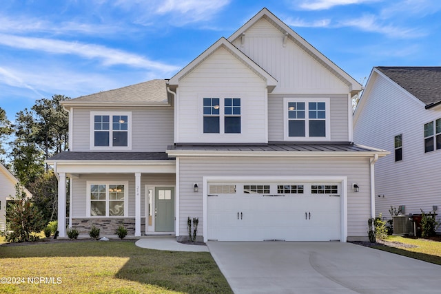 craftsman-style home featuring cooling unit, a front yard, and a garage