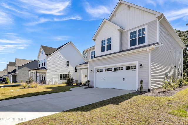 view of front of property with a front yard and a garage