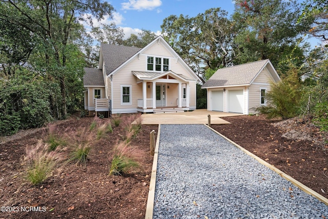 view of front of home featuring covered porch and a garage