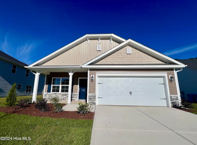 craftsman inspired home featuring a porch and a garage