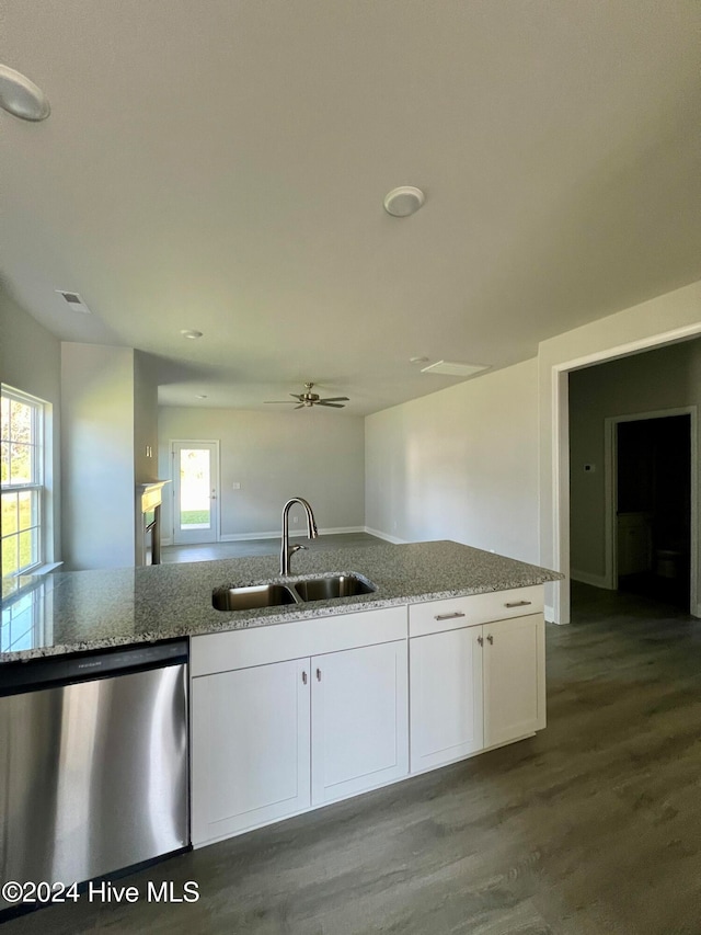 kitchen featuring light stone countertops, sink, stainless steel dishwasher, hardwood / wood-style floors, and white cabinets