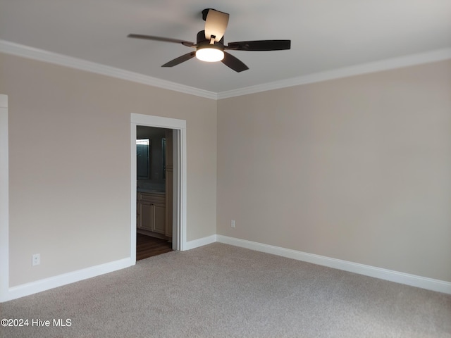 spare room with ceiling fan, ornamental molding, and carpet floors