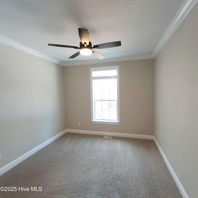 spare room featuring visible vents, baseboards, ceiling fan, crown molding, and carpet flooring