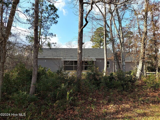 back of house featuring a sunroom