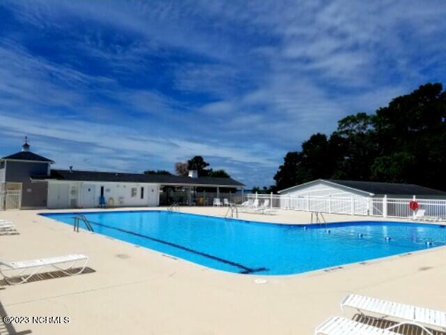 pool featuring fence and a patio