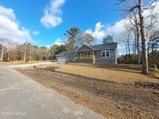 view of front of property with a porch and a garage