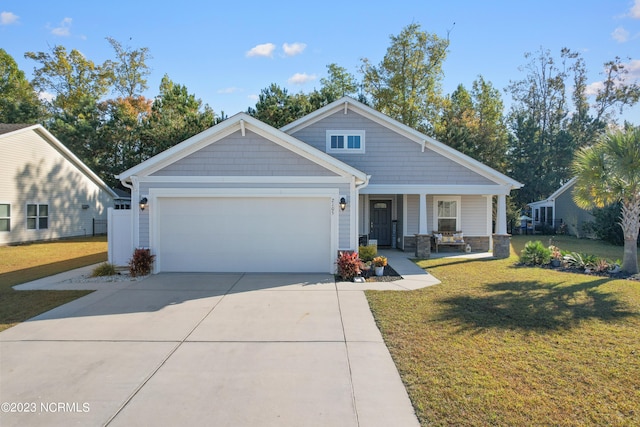 craftsman house featuring a garage, a porch, and a front yard