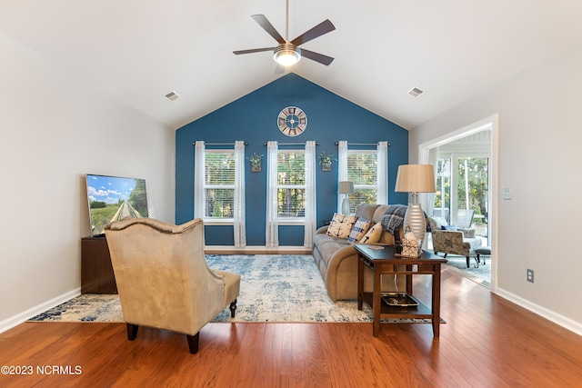 living room featuring wood-type flooring, ceiling fan, and high vaulted ceiling