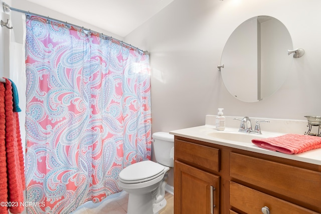 bathroom featuring tile patterned floors, toilet, and vanity