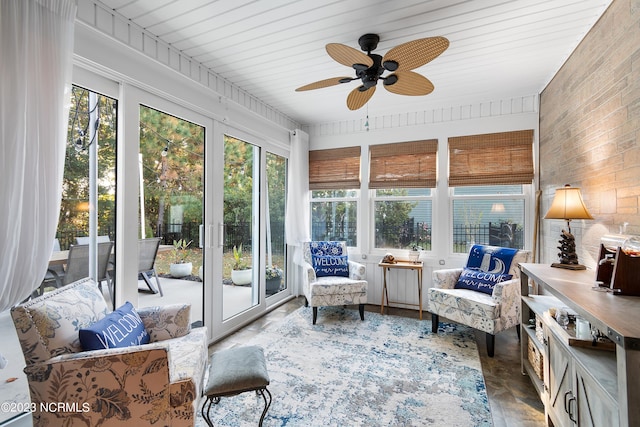 sunroom / solarium featuring ceiling fan