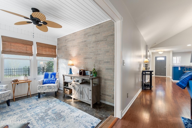 interior space featuring ceiling fan, dark hardwood / wood-style flooring, and vaulted ceiling