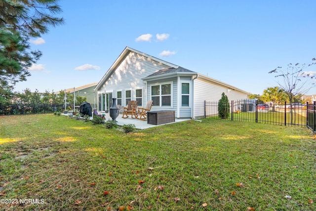 rear view of house with a patio area, an outdoor hangout area, and a yard