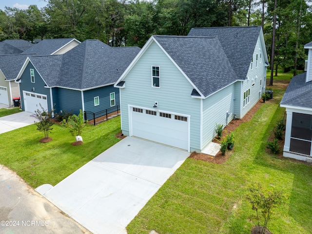 view of front facade with a garage and a front lawn