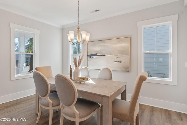 kitchen featuring a kitchen island with sink, appliances with stainless steel finishes, hardwood / wood-style flooring, and white cabinetry