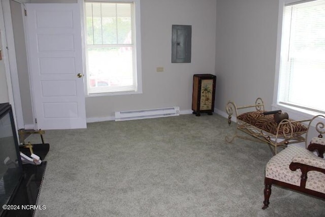 sitting room featuring a baseboard radiator, baseboards, electric panel, and carpet flooring