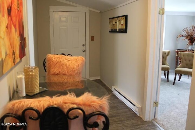 interior space with a baseboard radiator, ornamental molding, dark colored carpet, and dark wood finished floors