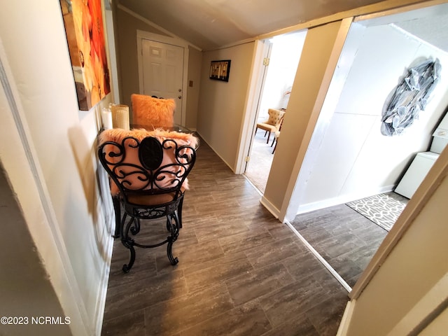 hall featuring vaulted ceiling and wood finished floors