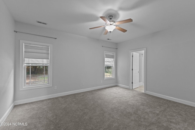 carpeted empty room featuring ceiling fan