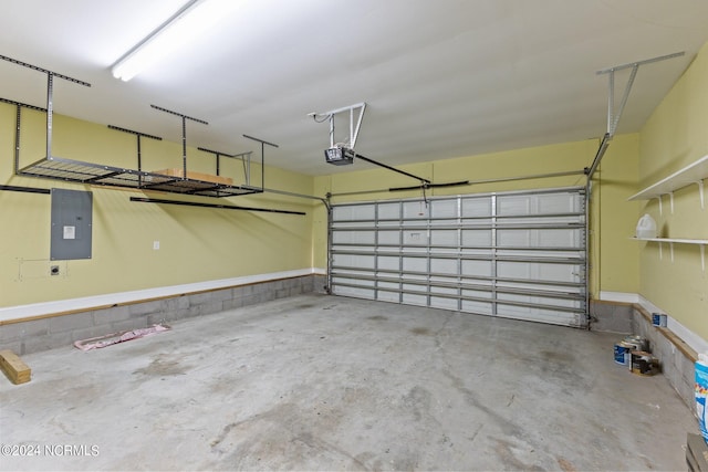 garage with a garage door opener and electric panel