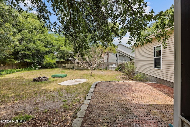 view of yard with a patio area and an outdoor fire pit