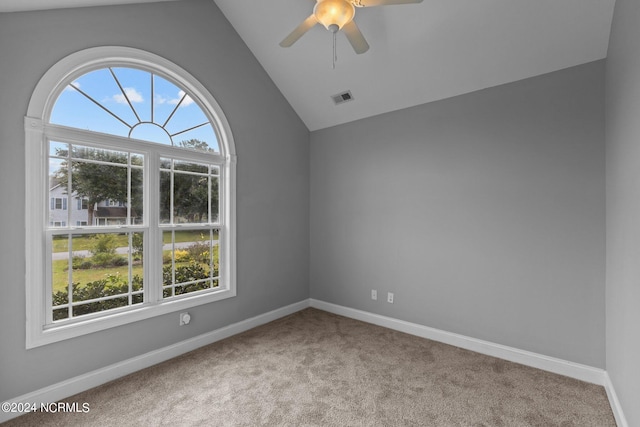 empty room featuring light carpet, lofted ceiling, and ceiling fan