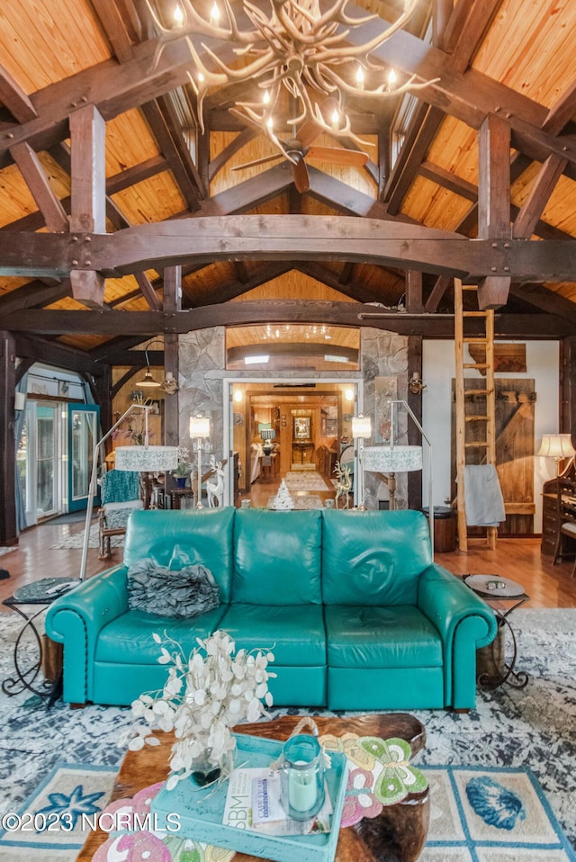 living area with wooden ceiling, wood finished floors, and vaulted ceiling with beams