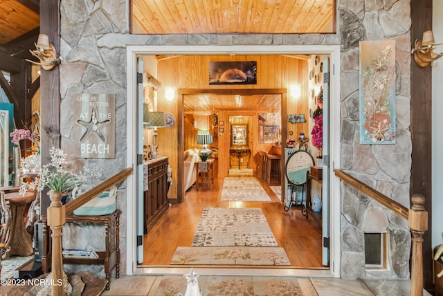 hallway with wood ceiling and wood finished floors