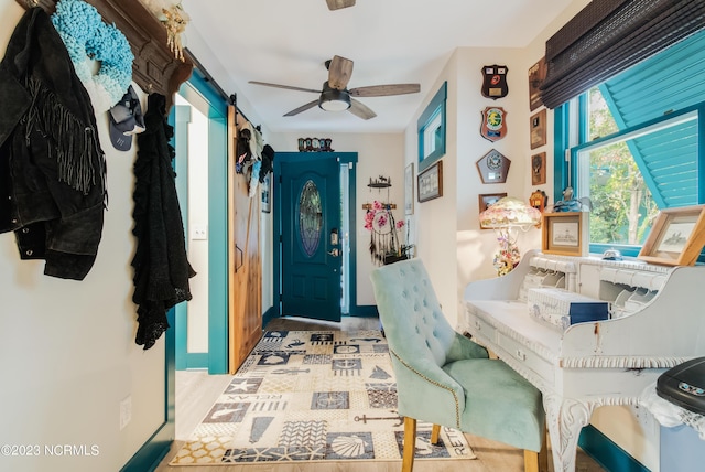 entryway featuring a barn door and a ceiling fan