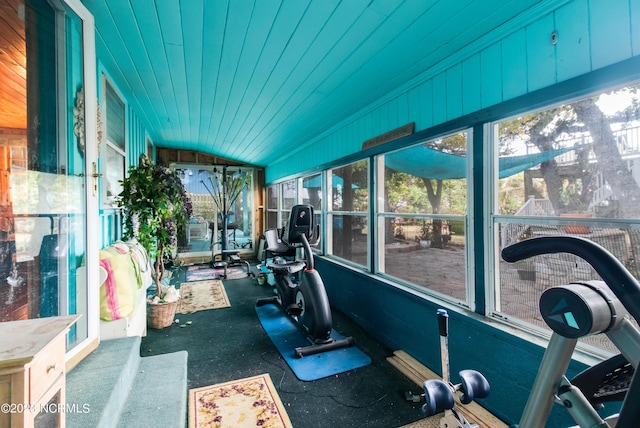 exercise room featuring lofted ceiling and wood ceiling