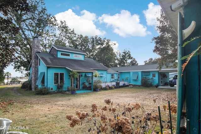 view of front of house with an attached carport and a chimney