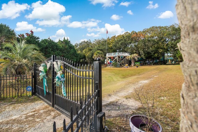 view of gate featuring a yard and fence