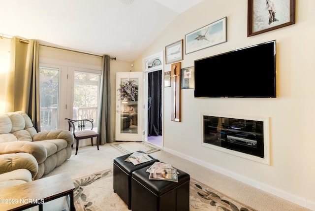 living room with baseboards, lofted ceiling, and light colored carpet