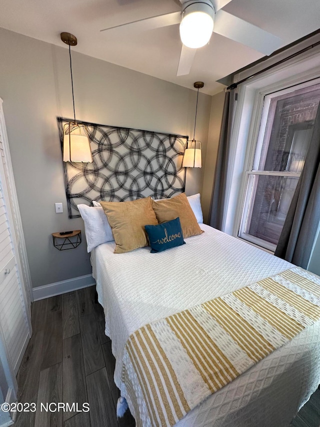 bedroom with ceiling fan and dark hardwood / wood-style flooring