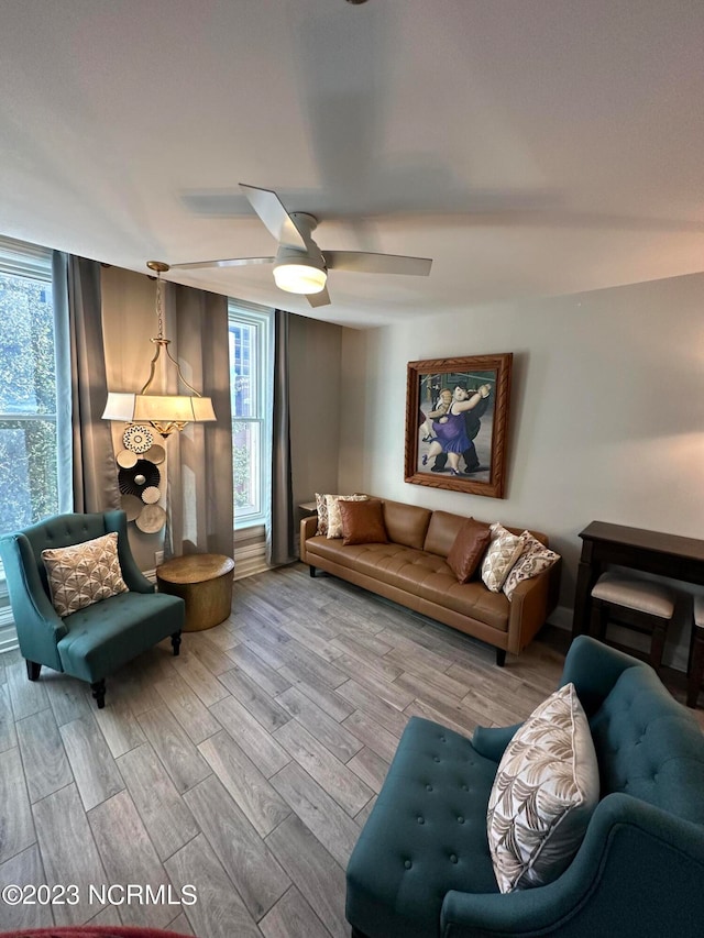 living room with ceiling fan and light hardwood / wood-style flooring