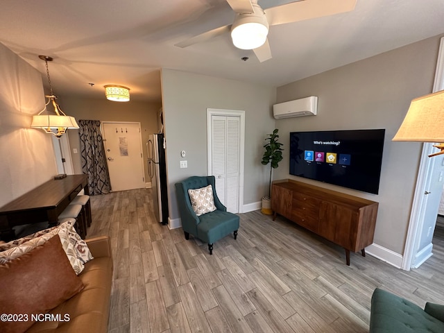 living room featuring hardwood / wood-style floors, ceiling fan, and a wall mounted air conditioner