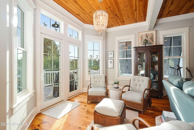 sunroom with a chandelier and wooden ceiling