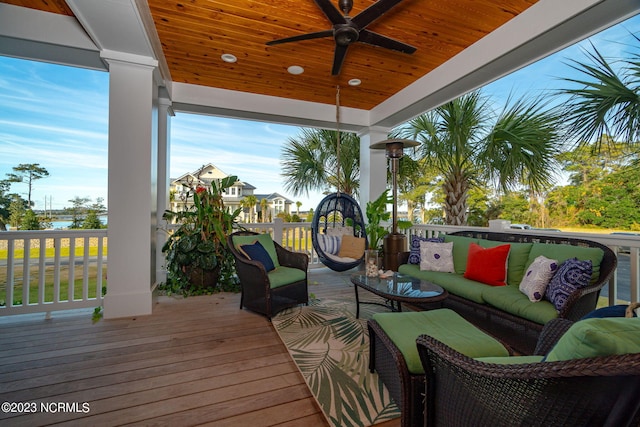 wooden terrace featuring outdoor lounge area and ceiling fan