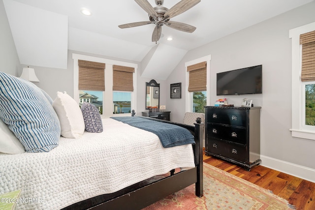 bedroom with ceiling fan, access to exterior, vaulted ceiling, and hardwood / wood-style floors